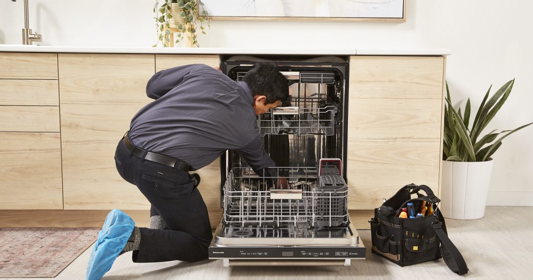 technician checking inside the dishwasher to find reasons why the dishwasher is not starting