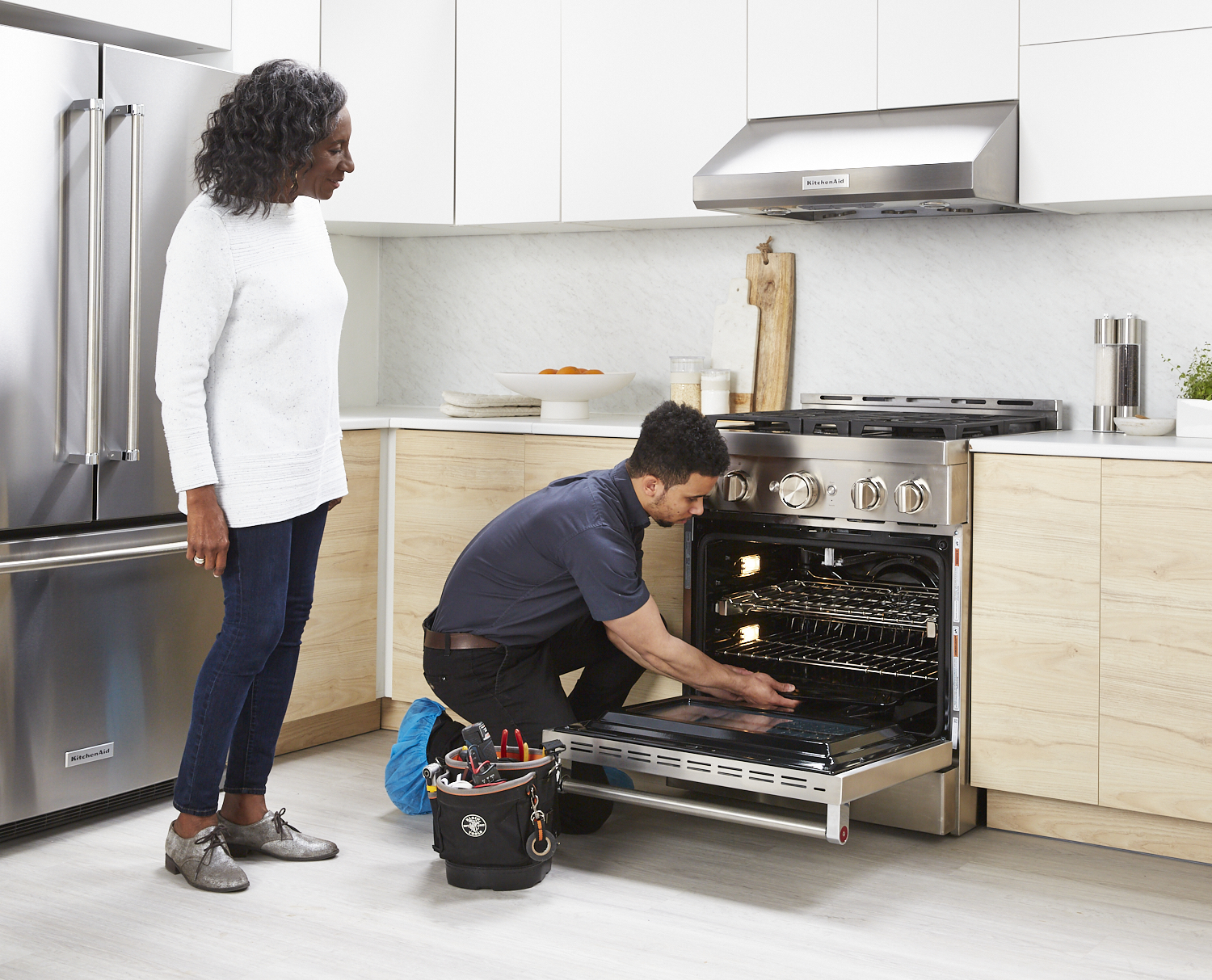 oven repair technician diagnosing an oven issue