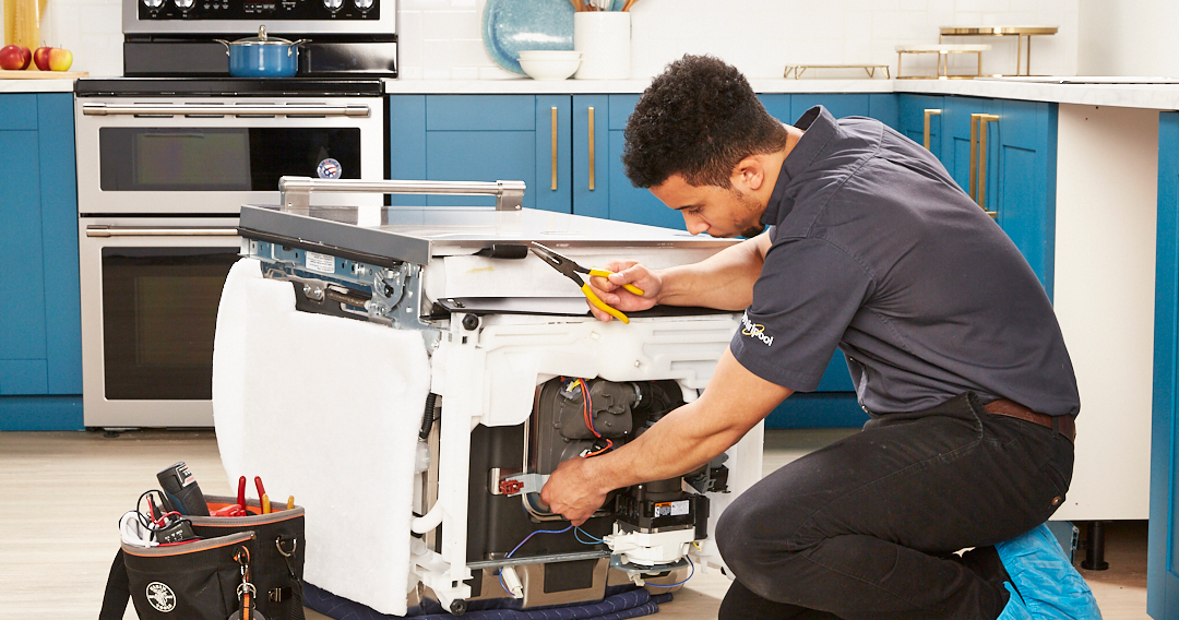 appliance technician repairing dishwasher