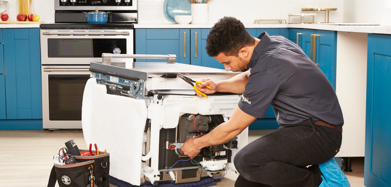 Appliance Technician Repairing Dishwasher