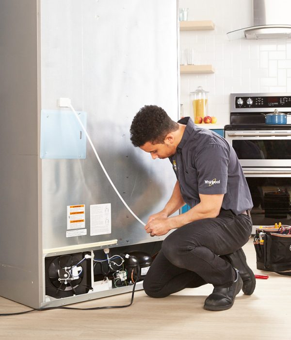 Technician Repairing Refrigerators