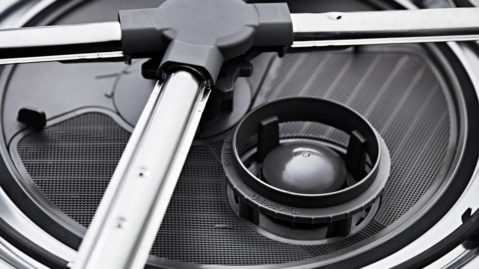 The inside of a dishwasher with the filter and spray jets.