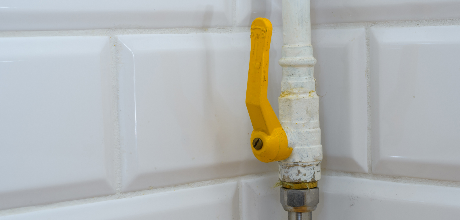 A pipe with a yellow valve.
